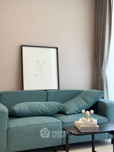 Stylish living room with modern teal sofa and elegant decor, perfect for cozy relaxation.