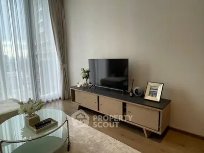 Modern living room with sleek TV stand and large window view