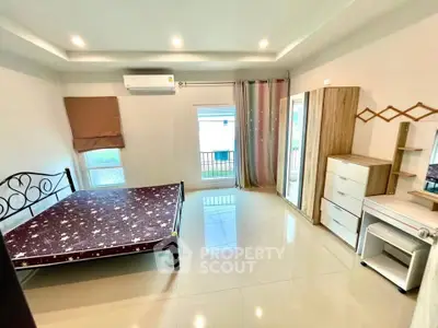 Spacious bedroom with modern furnishings and natural light in a stylish apartment.
