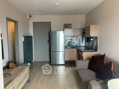Modern apartment interior with compact kitchen and cozy living area