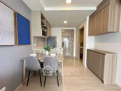 Modern dining area with stylish decor and open kitchen layout in a contemporary apartment.