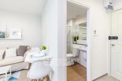 Modern compact apartment with cozy living area and sleek bathroom design.