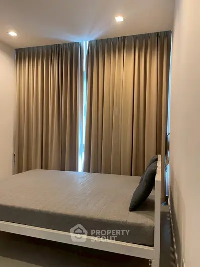 Cozy bedroom with modern design and floor-to-ceiling curtains