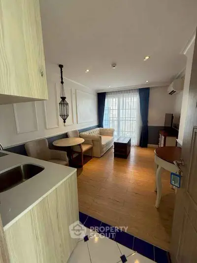 Charming living room with elegant decor and natural light, featuring cozy seating and modern amenities.