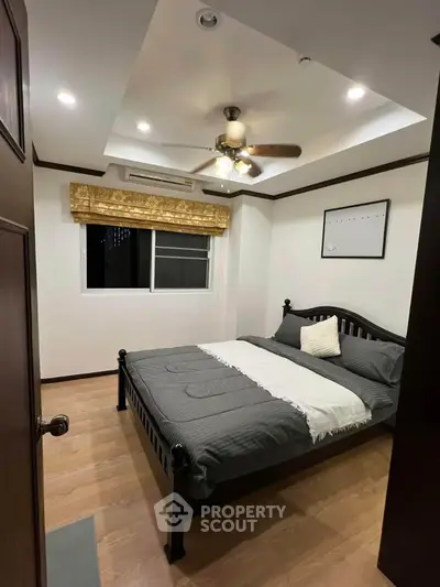 Cozy bedroom with modern ceiling fan and elegant decor