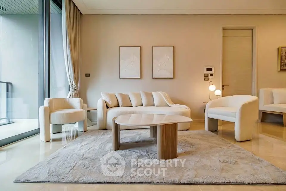 Luxurious modern living room with elegant furniture and large windows.