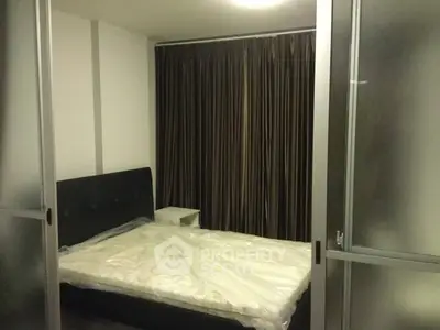 Cozy bedroom with modern sliding doors and elegant curtains, perfect for restful nights.