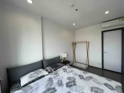 Modern bedroom with stylish decor and ample natural light