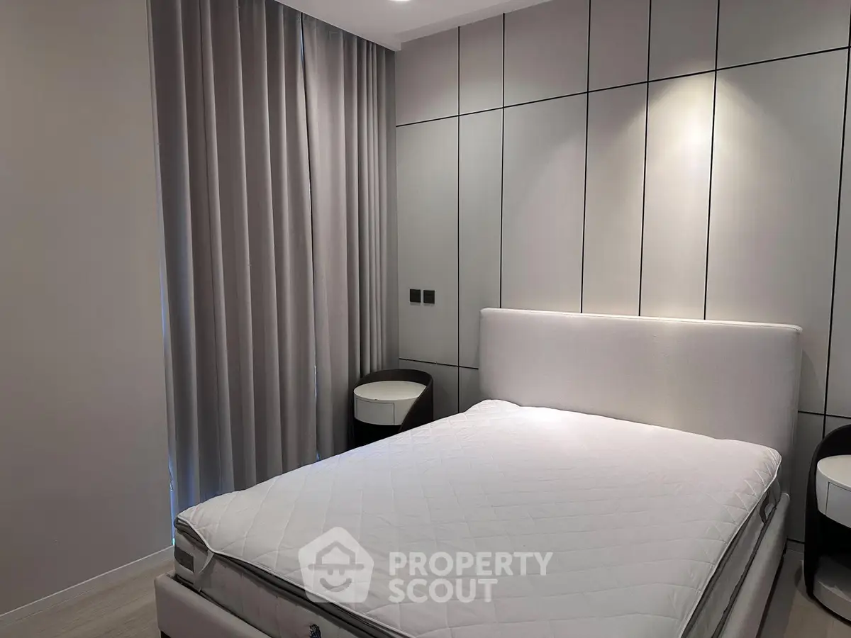 Modern bedroom with sleek design and elegant furnishings in a stylish apartment.