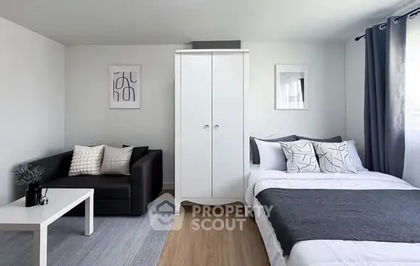 Modern studio apartment with cozy living area and stylish decor