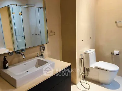 Modern bathroom with sleek fixtures and spacious design in a luxury apartment.