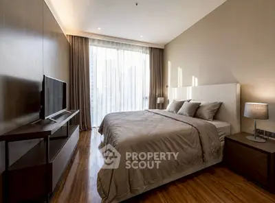 Luxurious bedroom with modern decor and large window offering city views, perfect for urban living.