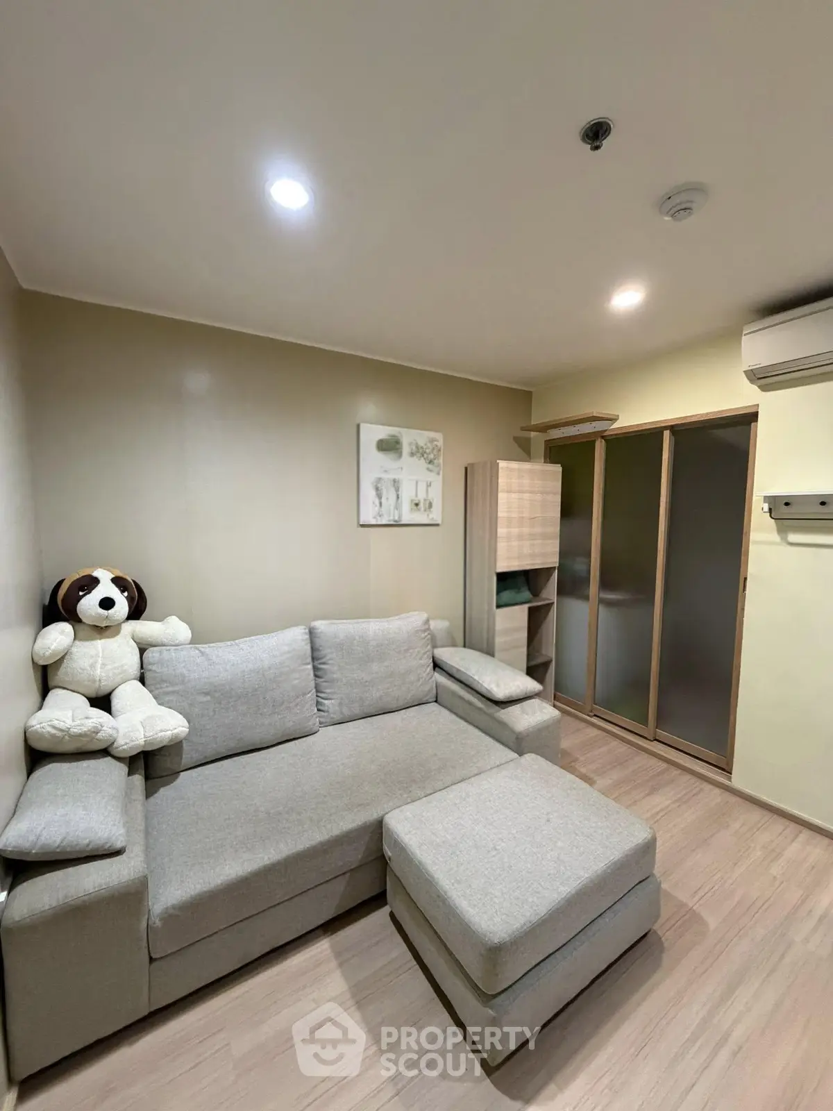 Cozy living room with modern sofa and plush decor in a stylish apartment.