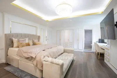 Luxurious bedroom with elegant decor, plush bed, and modern lighting in upscale home.