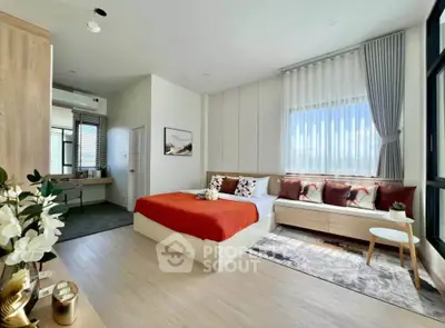 Spacious modern bedroom with large window and stylish decor