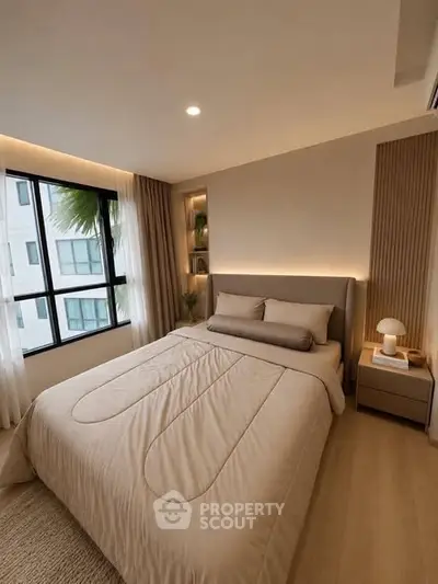 Modern bedroom with cozy lighting and large window in stylish apartment