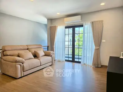 Spacious living room with modern sofa and balcony view