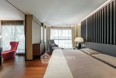 Luxurious modern bedroom with elegant decor and large windows for natural light.