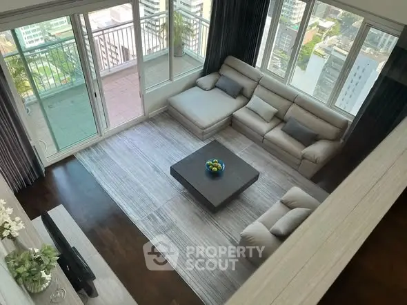 Spacious living room with large windows and balcony view in modern apartment