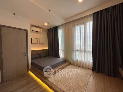 Modern bedroom with platform bed and ambient lighting in stylish apartment