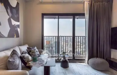 Stylish living room with city view balcony, modern decor, and cozy seating area.