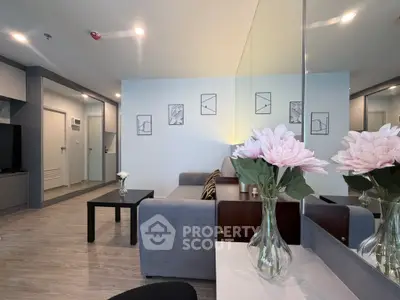 Modern living room with stylish decor and elegant furniture, featuring a cozy sofa and decorative wall art.