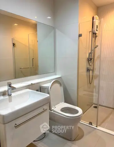 Modern bathroom with sleek fixtures and glass shower enclosure