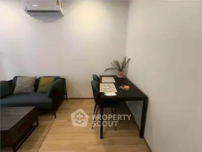 Modern living room with cozy seating and stylish workspace, perfect for urban living.