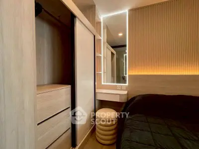 Modern bedroom with built-in wardrobe and stylish lighting