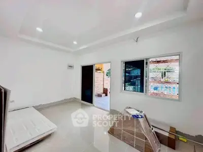 Spacious room with sliding glass door and pool view, ideal for modern living.