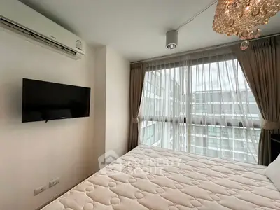 Modern bedroom with large windows, air conditioning, and elegant chandelier in a high-rise apartment.