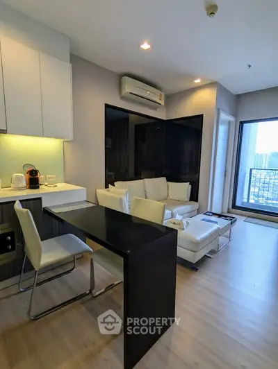 Modern living room with sleek furniture and balcony view in a stylish apartment
