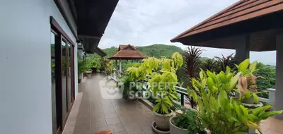 Stunning balcony with lush greenery and scenic mountain views, perfect for relaxation and outdoor enjoyment.
