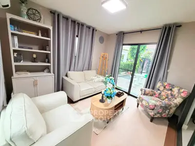 Charming living room with elegant decor and garden view, featuring cozy seating and modern design.