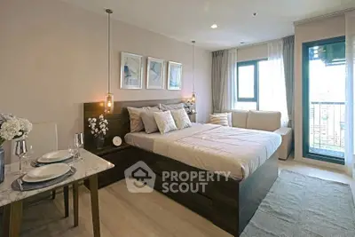 Modern bedroom with elegant decor and balcony view in a stylish apartment