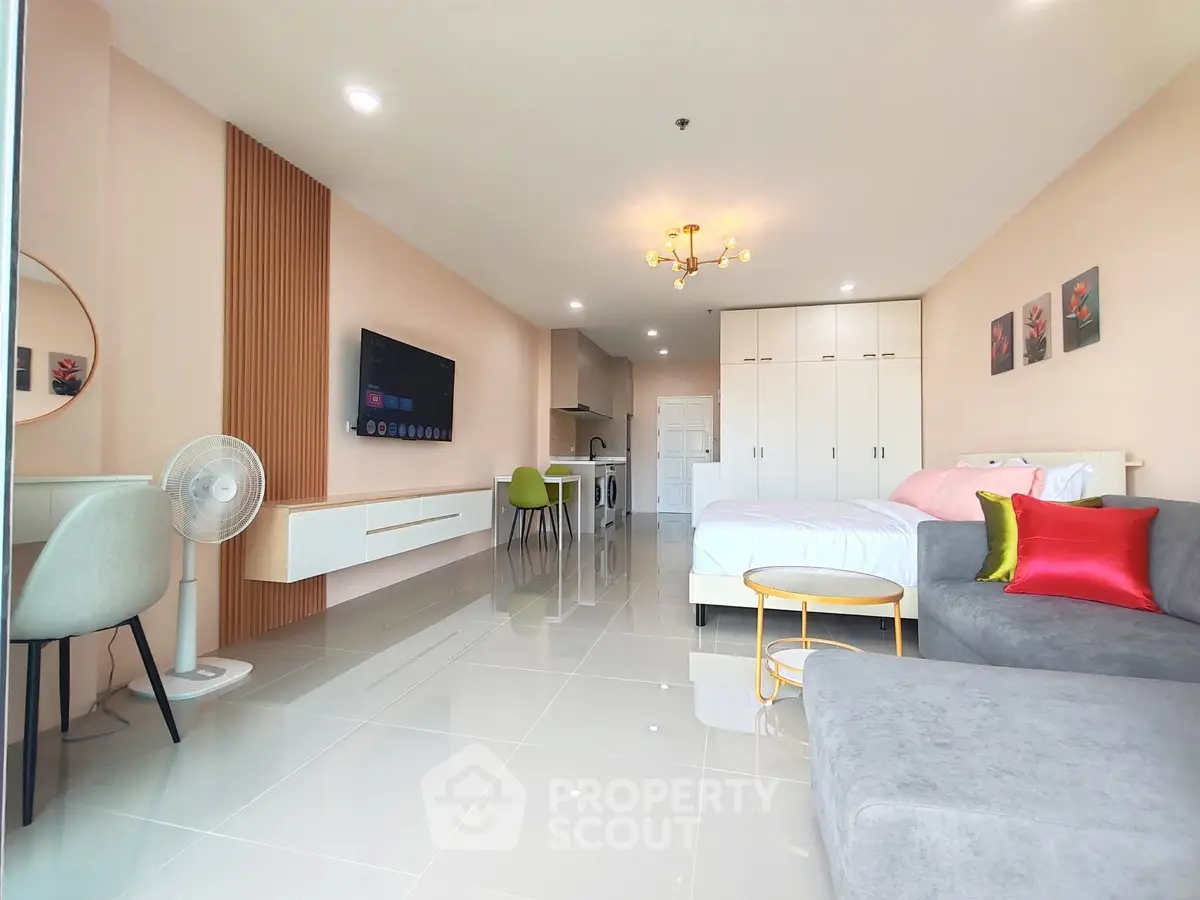 Modern studio apartment with open layout, featuring stylish furniture and sleek design.