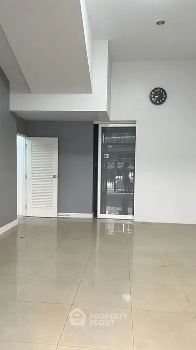 Spacious empty room with tiled floor and modern design