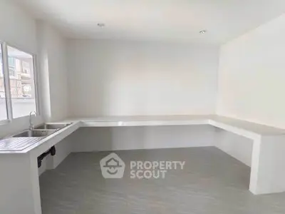 Spacious minimalist kitchen with ample counter space and natural light