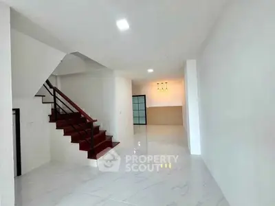 Spacious modern interior with sleek staircase and open layout, perfect for contemporary living.