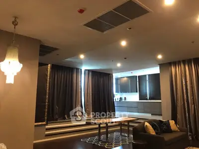 Luxurious open-plan living room with elegant lighting and modern kitchen