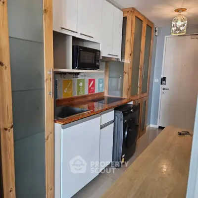 Modern kitchen with wooden accents and built-in appliances