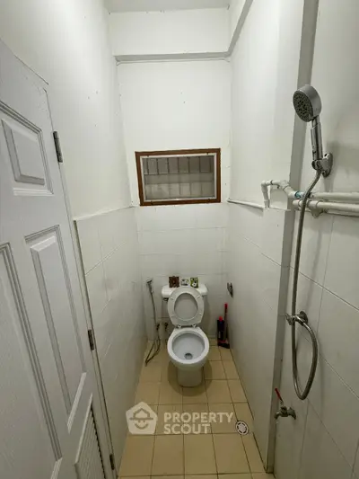 Compact bathroom with shower and toilet in minimalist design
