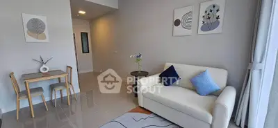 Modern living room with stylish decor, cozy sofa, and dining area in a bright apartment.