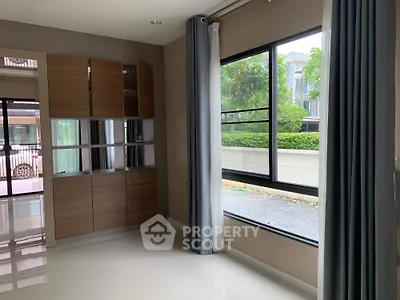 Bright interior room with large window and modern cabinetry