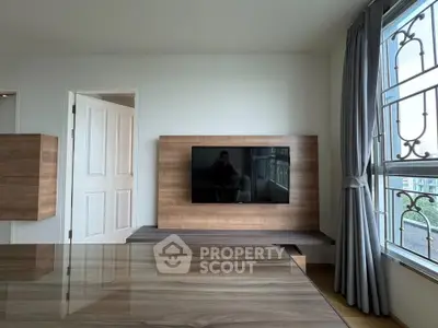 Modern living room with sleek wooden TV stand and large window view