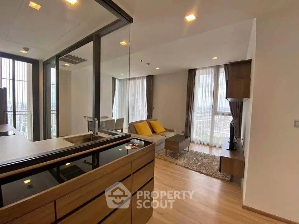 Modern living room with open layout and large windows offering city views