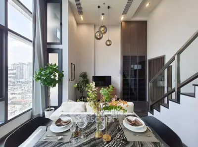 Luxurious modern living room with high ceilings and elegant dining area