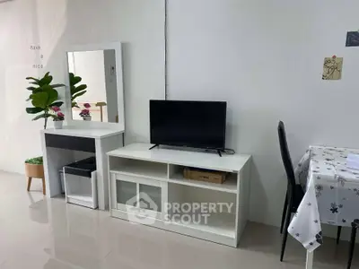 Modern living room with sleek TV stand and dining area