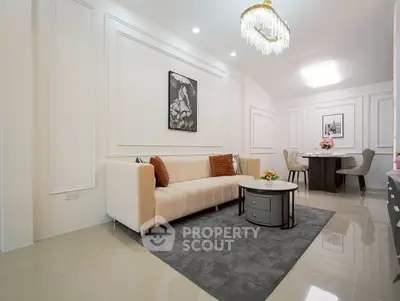 Elegant living room with modern decor and plush seating in a stylish apartment.