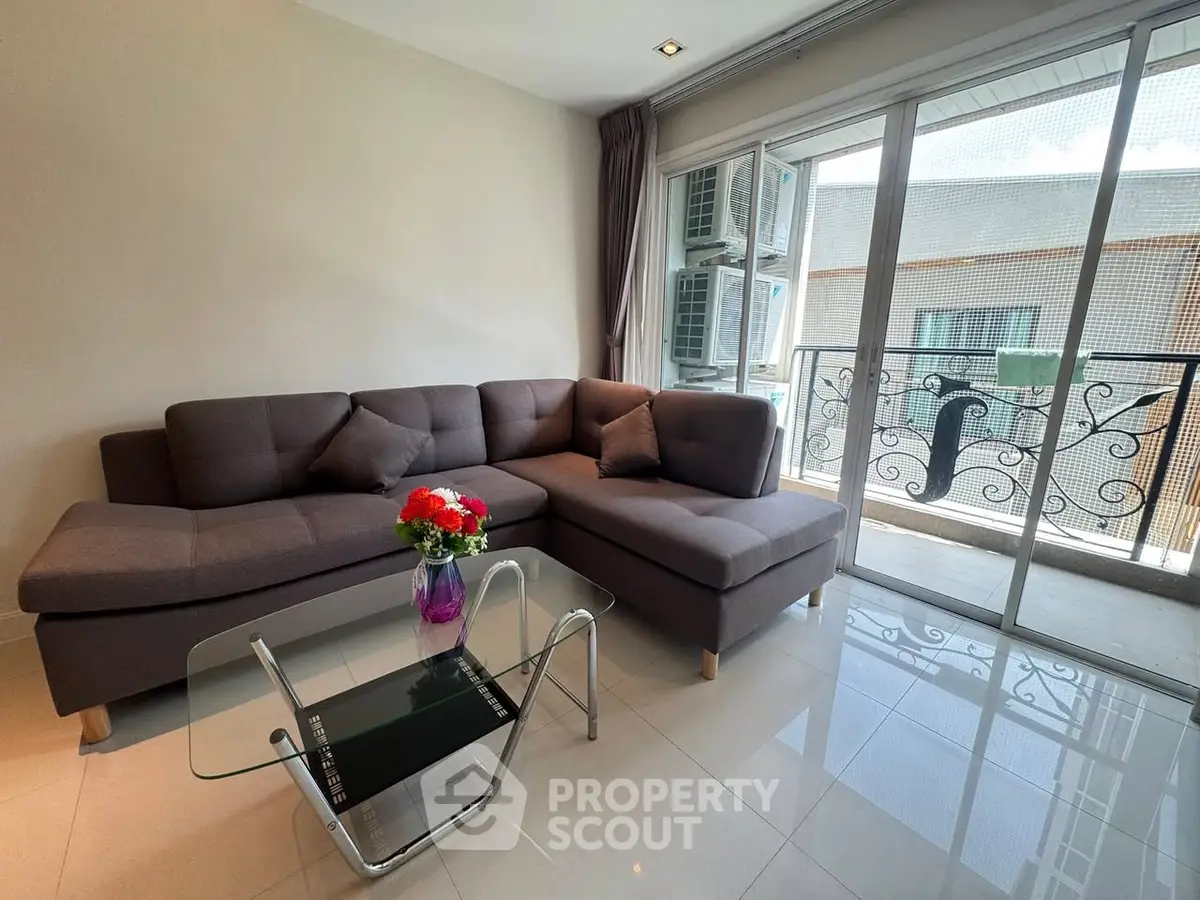 Modern living room with stylish sofa and balcony view